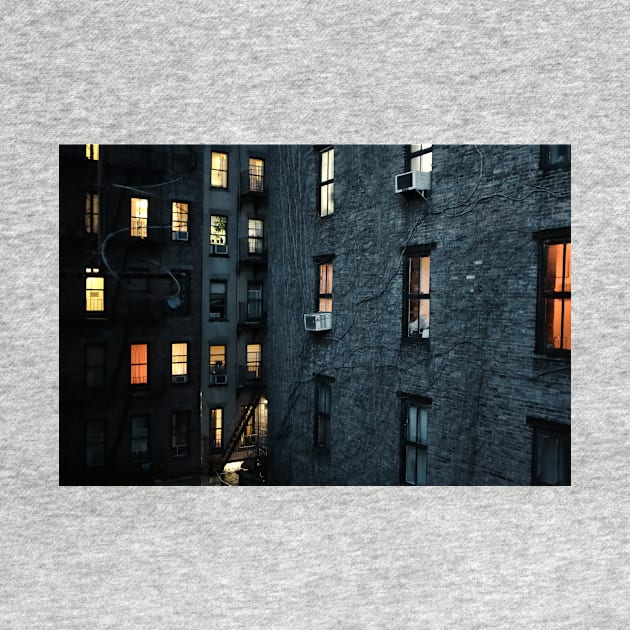 Illuminated windows in New York City courtyard at twilight by Reinvention